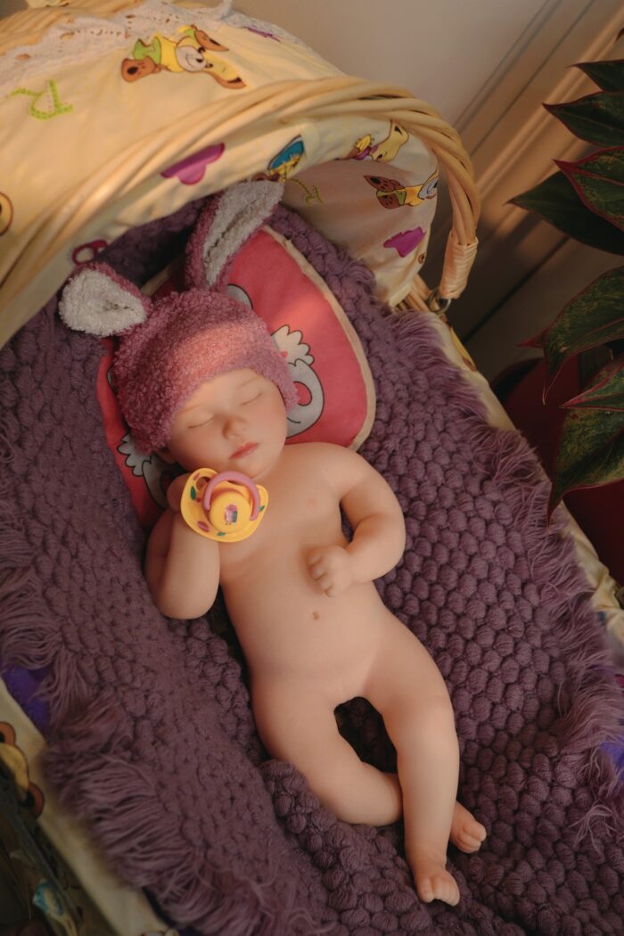 Silicone Reborn Baby Doll with Bunny Hat, Pacifier, and Soft Blanket.