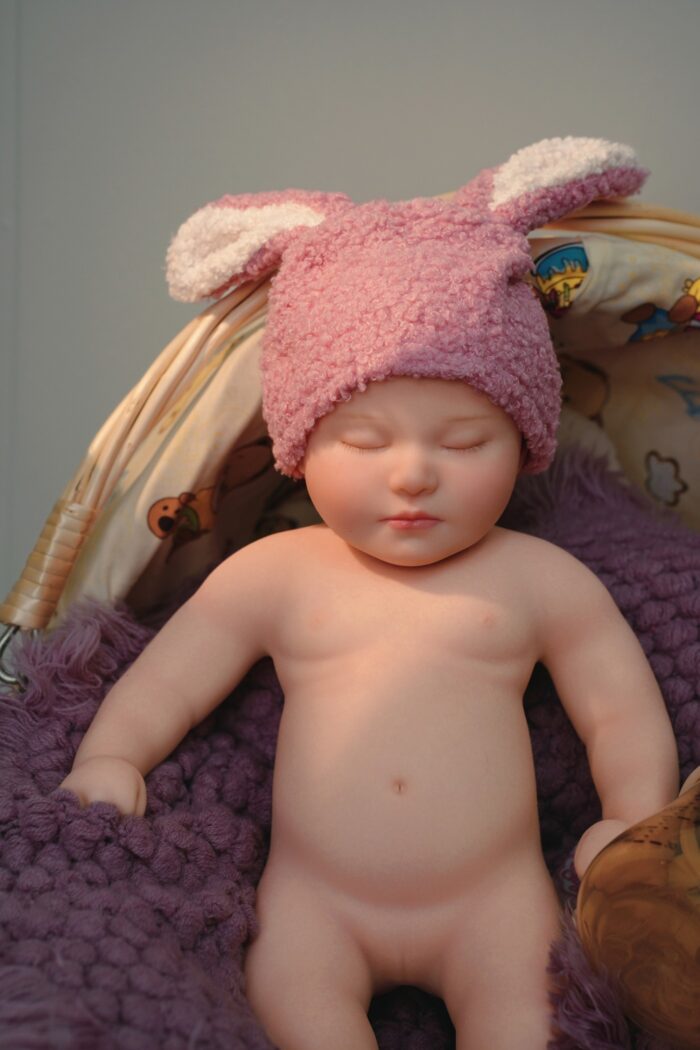 Realistic Bonnie silicone reborn doll with bunny hat.