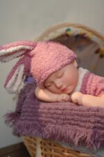 Silicone Reborn Baby Doll with Bunny Hat, realistic and soft for collectors and children.