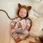 Baby Reborn doll wearing a cute bear hoodie and pajamas, perfect for a gift or collection.