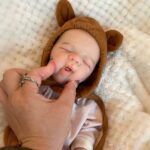 Reborn doll with bear hood, perfect 13-inch gift for collectors and children.