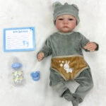 Reborn baby doll in soft vinyl, 18 inches, with open eyes and adorable bunny-themed clothing. Perfec.