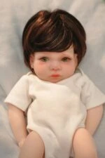 Reborn silicone doll with lifelike features, detailed hair, and soft skin, perfect for collectors an.