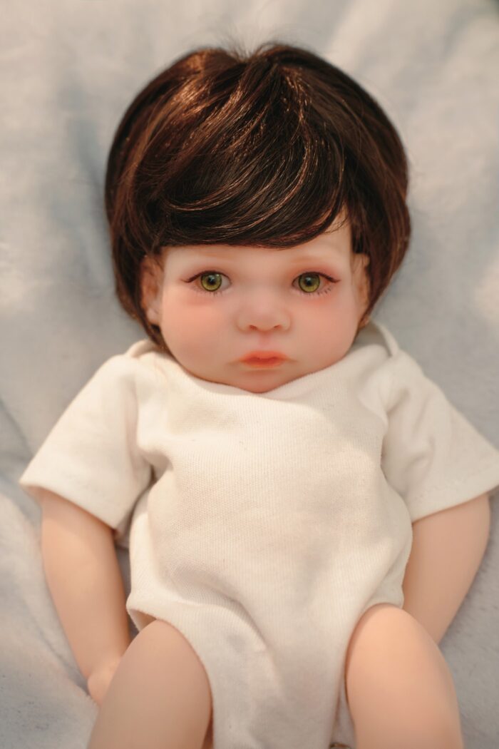 Reborn silicone doll with lifelike features, detailed hair, and soft skin, perfect for collectors an.