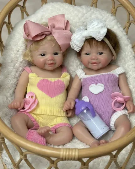 Realistic silicone baby doll twins with rooted hair, dressed in colorful outfits, in a cozy wicker b.