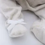 Adorable baby booties made of plush fabric with delicate white ribbon bows, perfect for reborn doll.