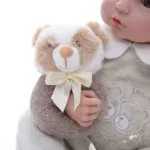 Reborn doll with plush teddy bear, realistic baby toy for collectors and children, soft and adorable.