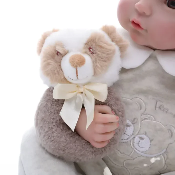 Reborn doll with plush teddy bear, realistic baby toy for collectors and children, soft and adorable.