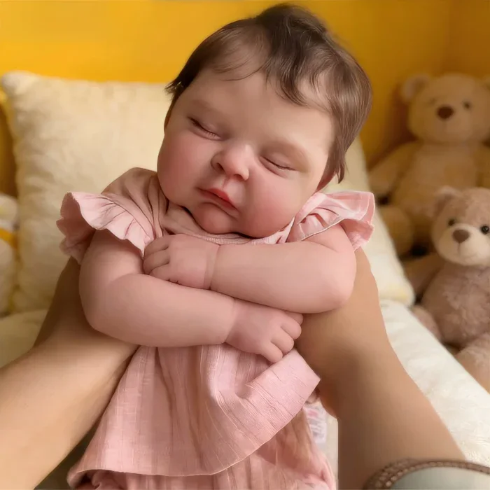 Realistic baby reborn doll sleeping with teddy bears, soft and lifelike.