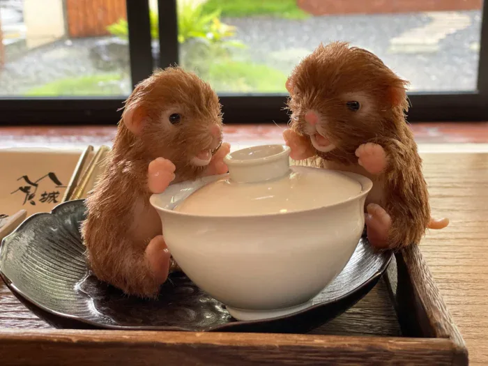 Adorable palm-sized silicone reborn puppy dolls with a teapot, perfect for collectors.