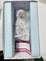 Adorable 7-inch silicone reborn baby girl doll in box with accessories.