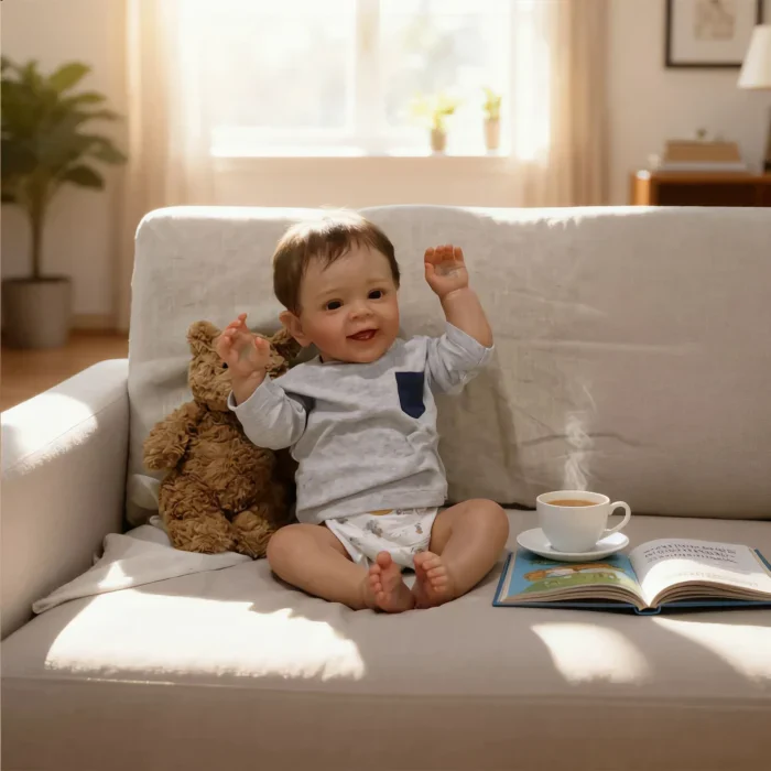 Happy toddler boy sitting on sofa with teddy bear and coffee.