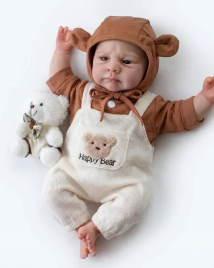 Realistic baby doll with bear hoodie and plush toy on white background.