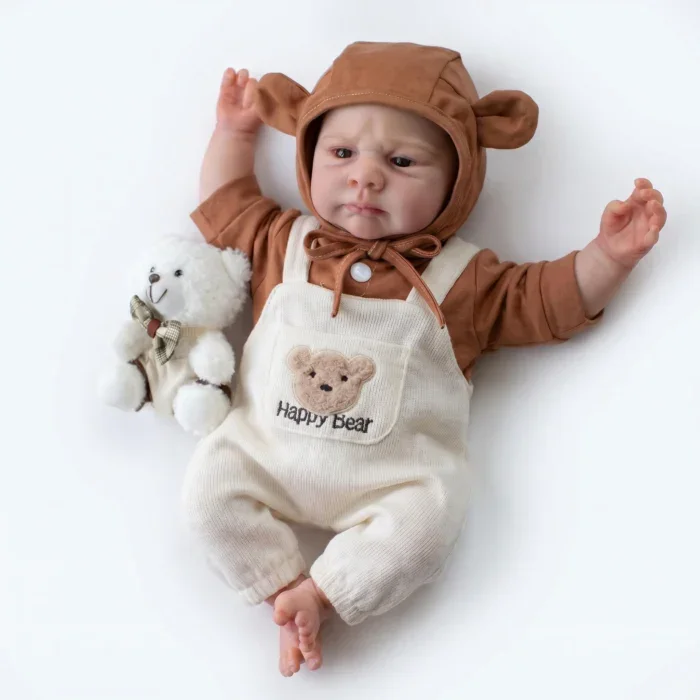 Realistic baby doll with bear hoodie and plush toy on white background.