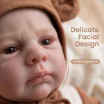 Close-up of a realistic baby doll face with delicate features and lifelike expression.