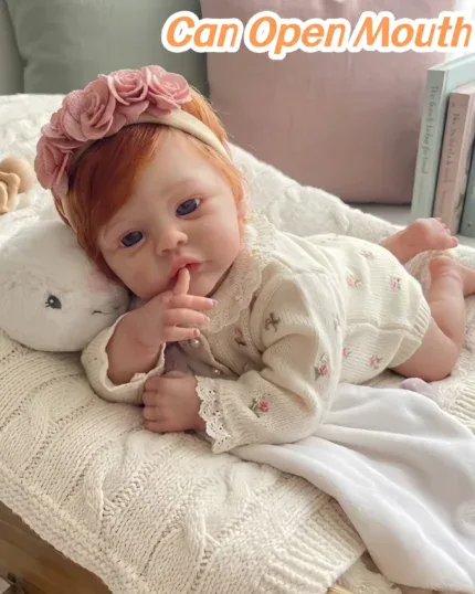 Adorable red-haired baby girl doll with open mouth and floral headband.