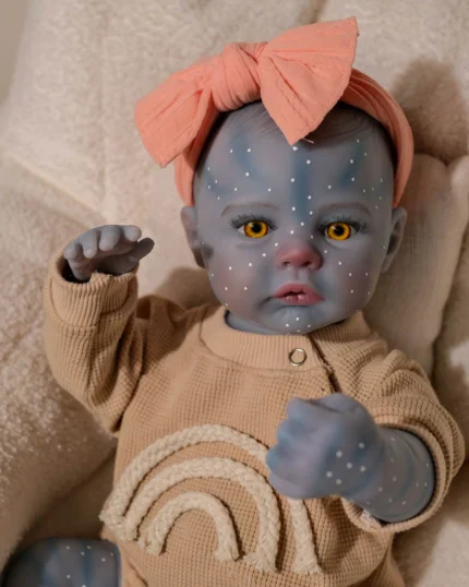 Blue-skinned reborn doll with yellow eyes and pink bow headband.