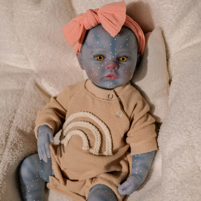 Blue-skinned girl reborn doll with rainbow and pink headband.