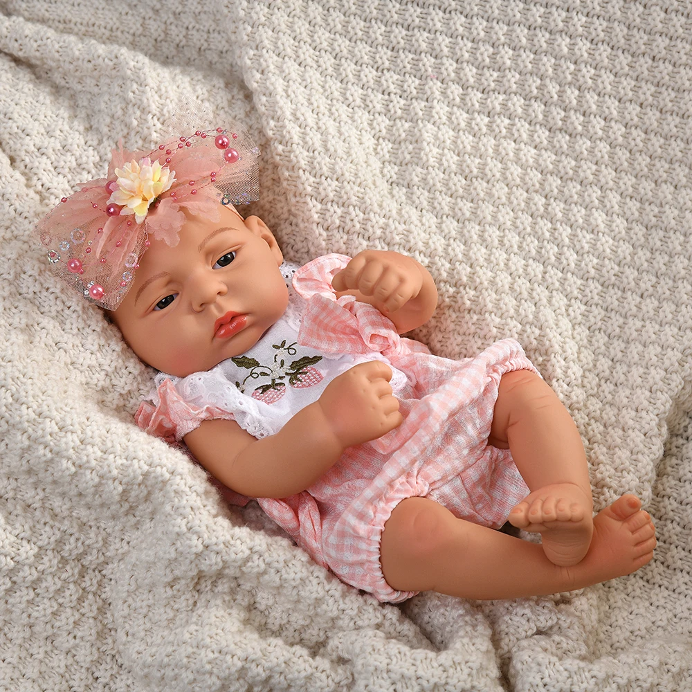 16 Inch Reborn Clothes Sweater Jumpsuit and Pinafore Set 76 Reborn baby doll with pink headband and matching outfit on cozy blanket.
