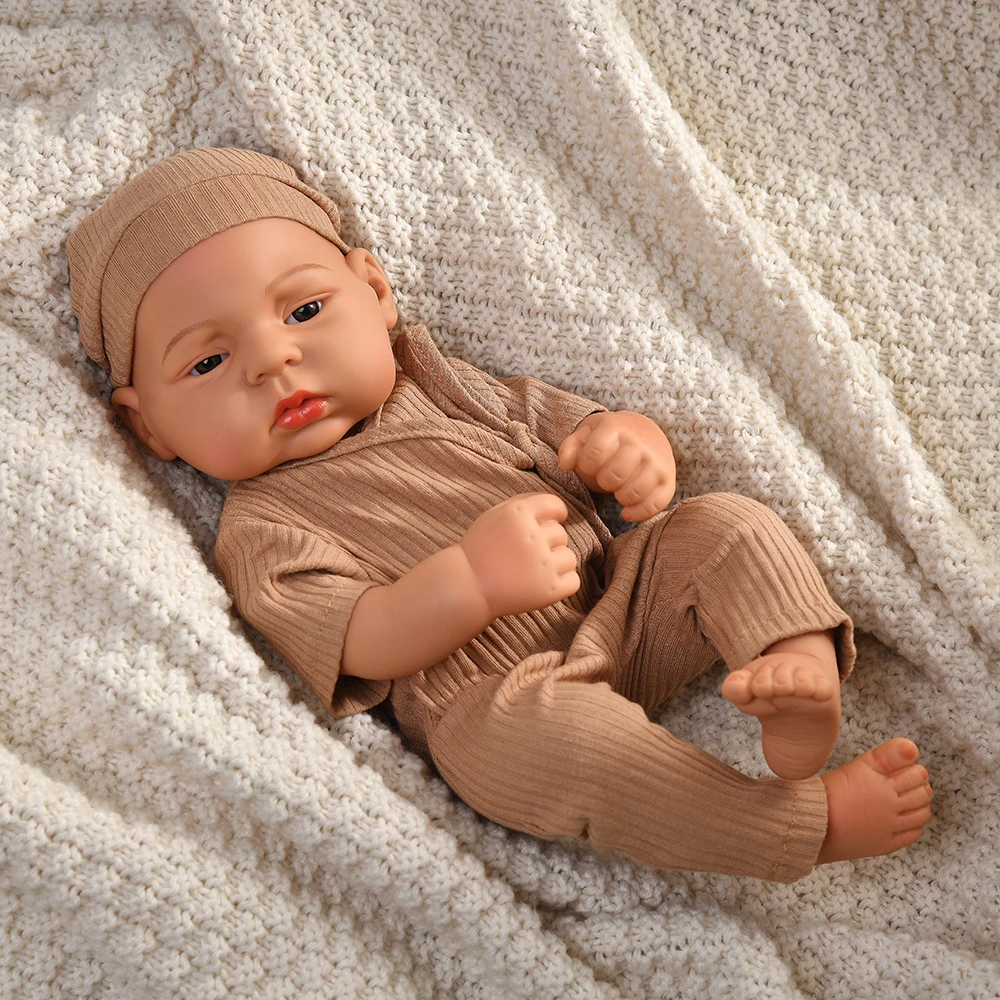 16 Inch Reborn Clothes Sweater Jumpsuit and Pinafore Set 82 Reborn baby doll wearing a beige sweater and matching pants on soft blanket.