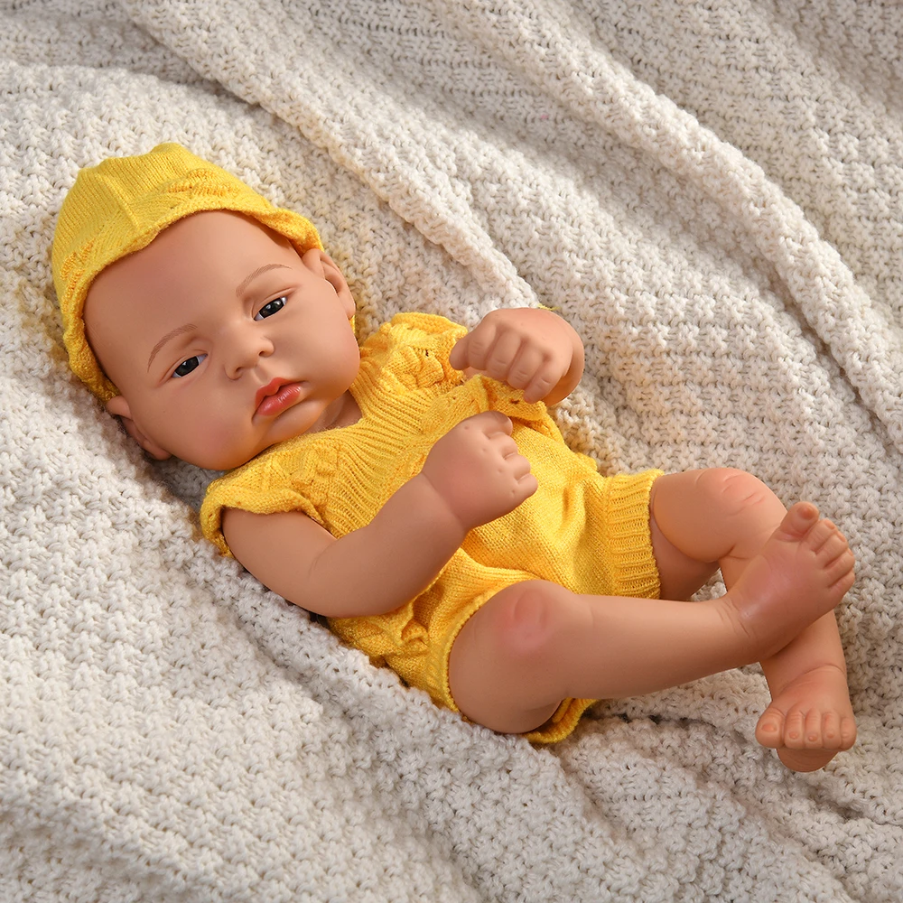 16 Inch Reborn Clothes Sweater Jumpsuit and Pinafore Set 84 Reborn baby doll wearing yellow sweater and hat on cozy blanket.