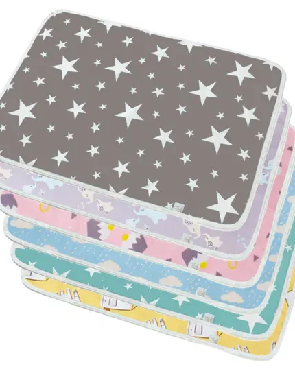 Stack of colorful doll changing mats with star and animal patterns.