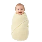 Adorable baby wrapped in a plain cotton gauze blanket for comfort and warmth.