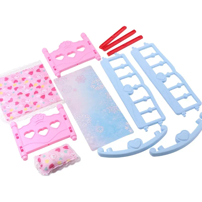 Pink and blue baby doll rocking bed with accessories for pretend play.