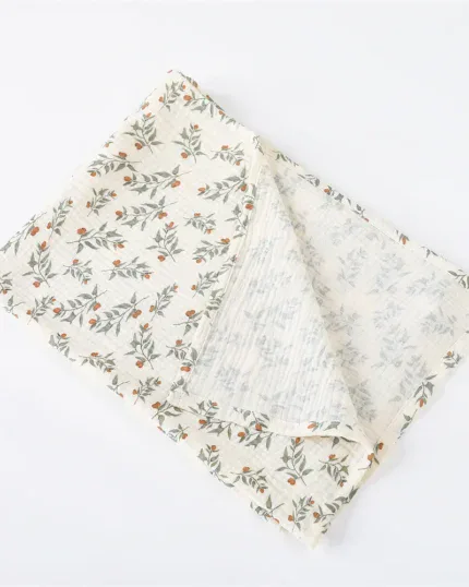 Soft muslin doll blanket with floral pattern for babies and photography.