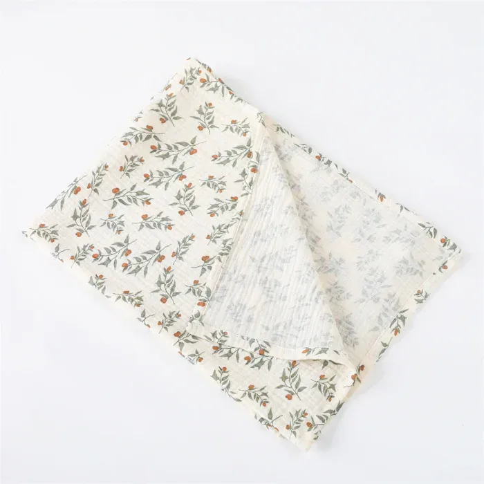 Soft muslin doll blanket with floral pattern for babies and photography.