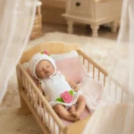 Mika baby girl sleeping reborn doll in knitted outfit.