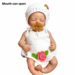 Mouth can open, sleeping baby doll with white knit outfit and pacifier.